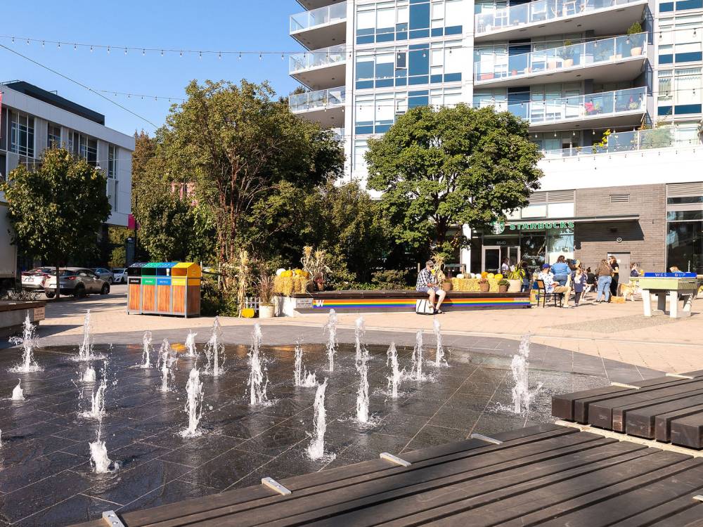 Water play feature in plaza during the day.