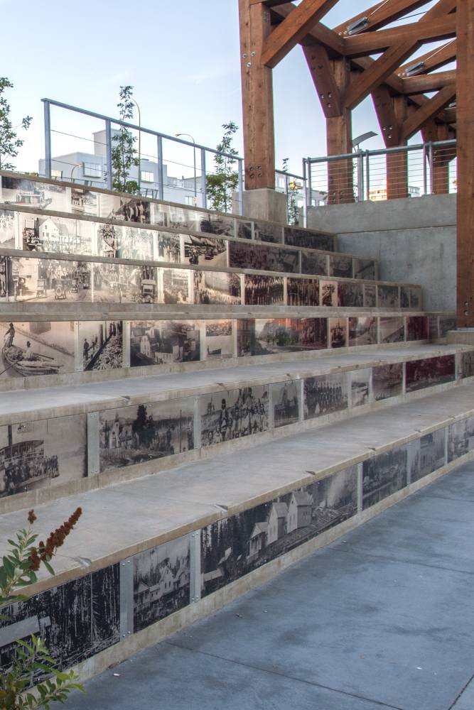 Historical photos on stone terrace seating.