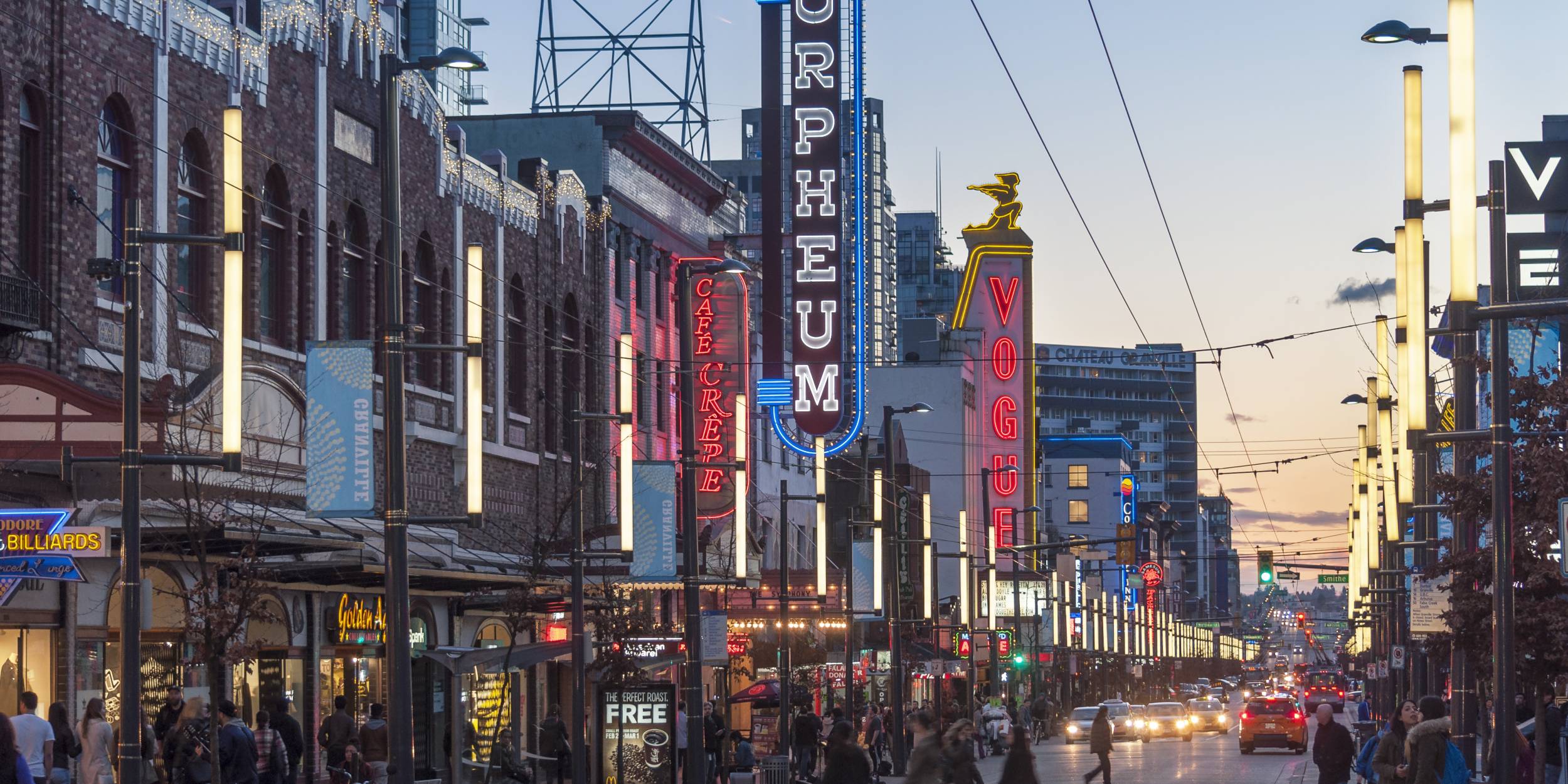 Waves of people walk along the busy entertainment strip of Granville Street.