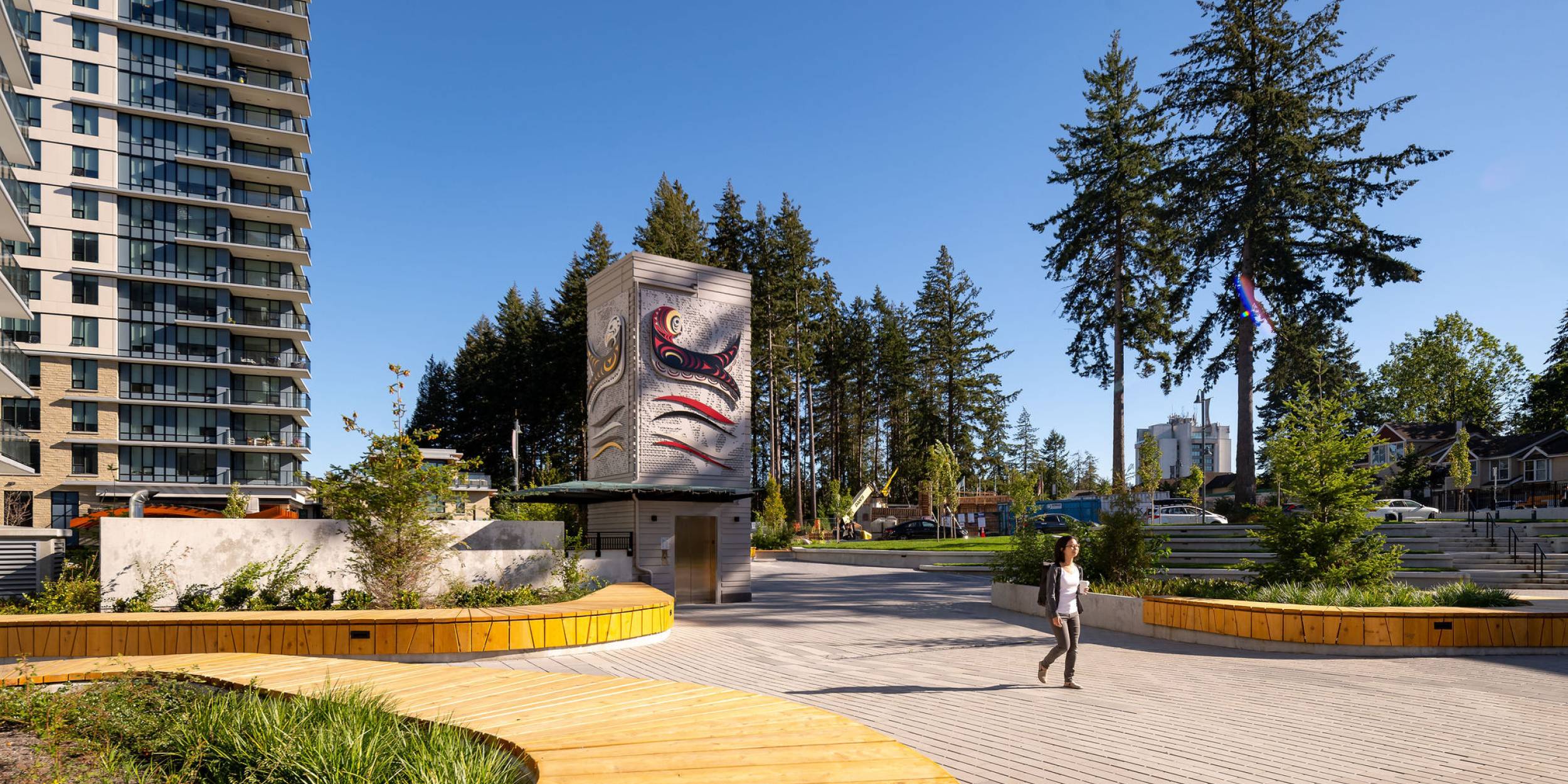 photo of person walking through plaza.