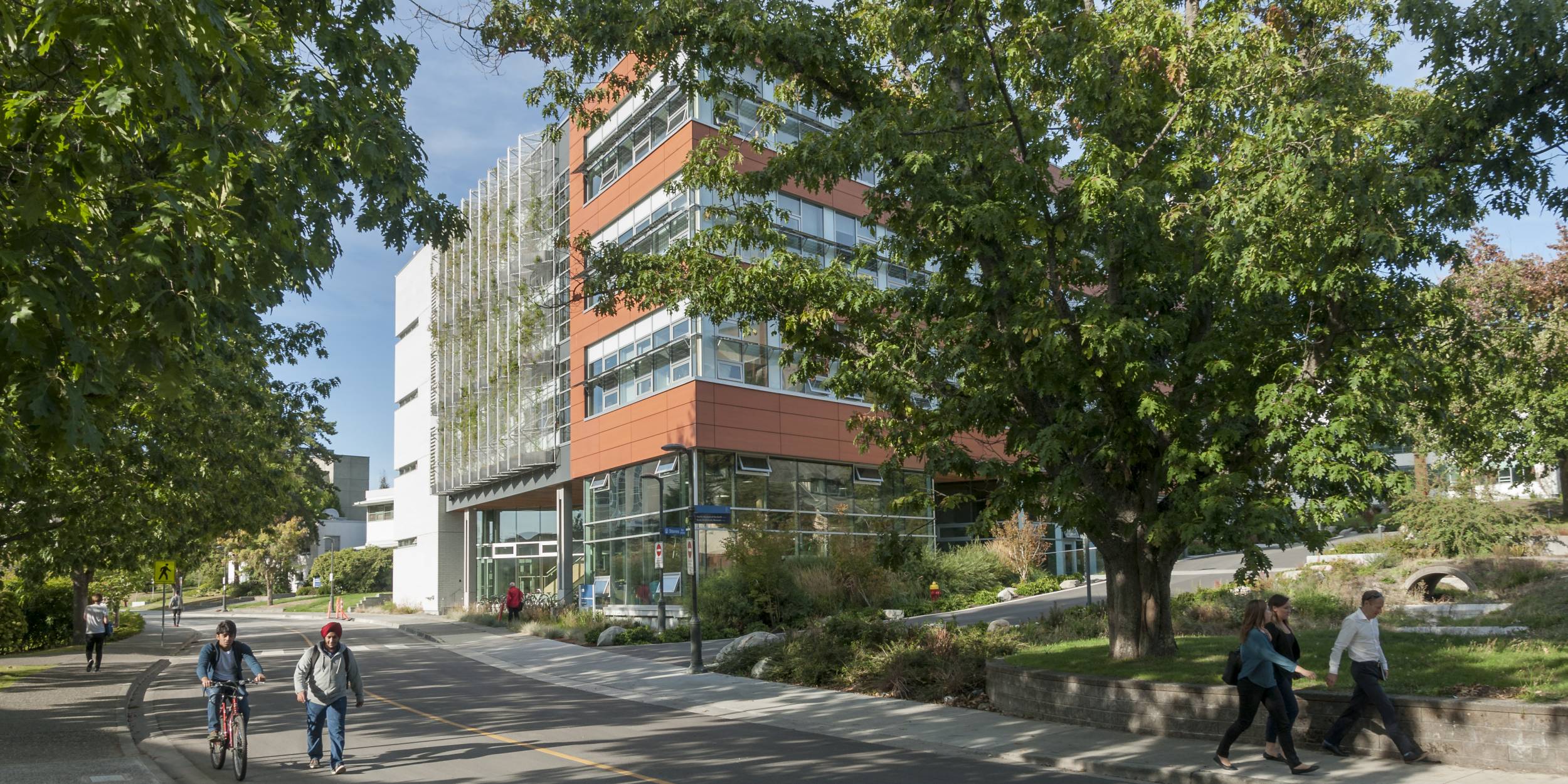 Students walk and bike past the CIRS building.