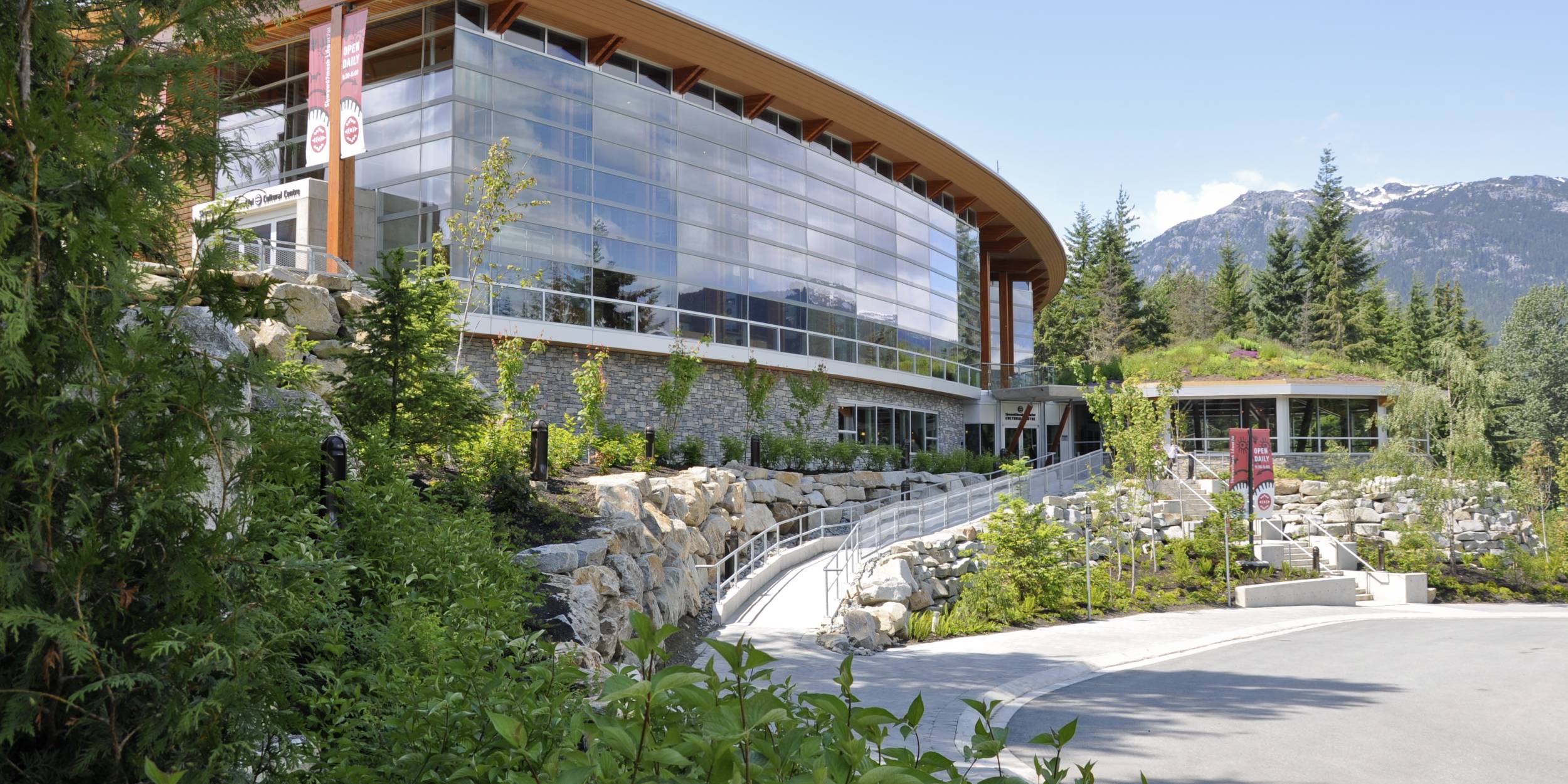 Exterior of Squamish Lil'wat cultural centre, showing the building's green roof.