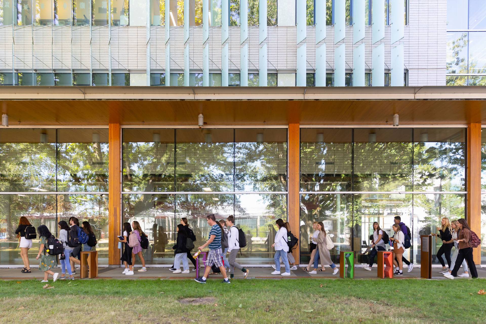 Photo of students walking past exhibit.
