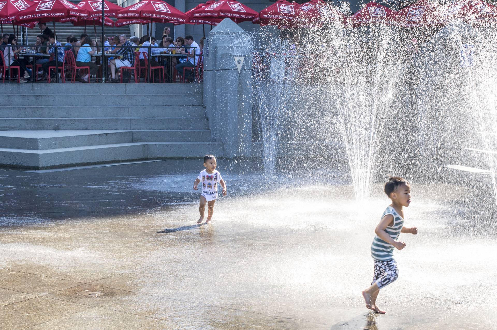 Kids play in the Harbour Green Spray Park.